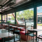 Nice inside photo lookign out to scarbrough beach road of PVC blinds installed on Spritz outdoor cafe area in Mount Hawthorn