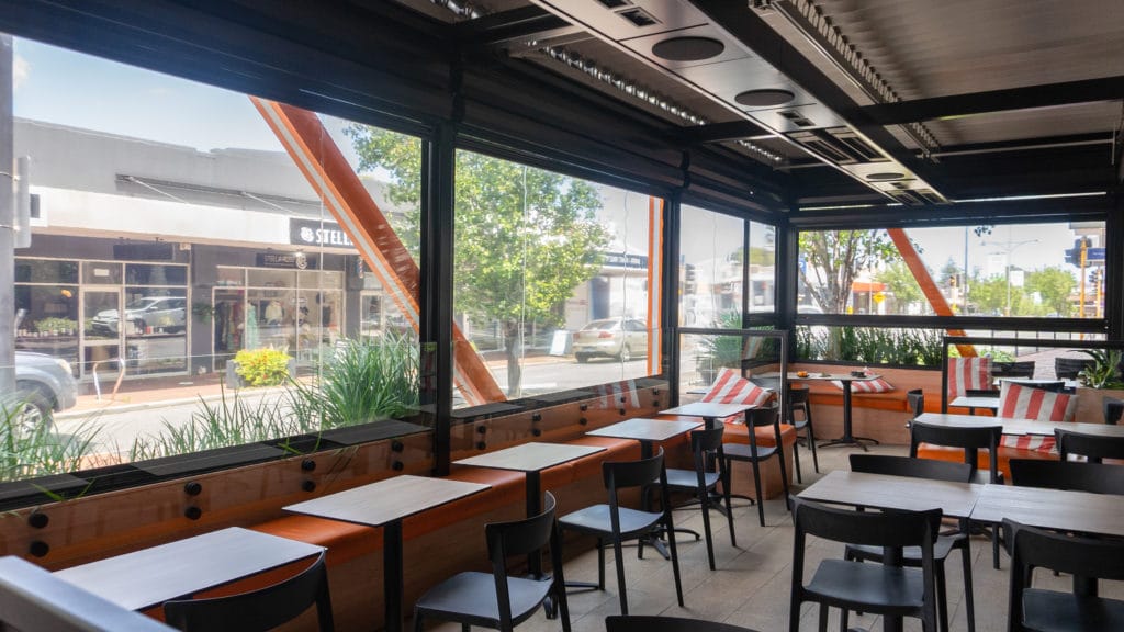 inside shot of a street side cafe patio area with Nu Style Blinds fitted to the exterior