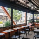 inside shot of a street side cafe patio area with Nu Style Blinds fitted to the exterior