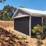 another shot of 2 outdoor ZIptrak® Blinds installed on a gable end farm styled home