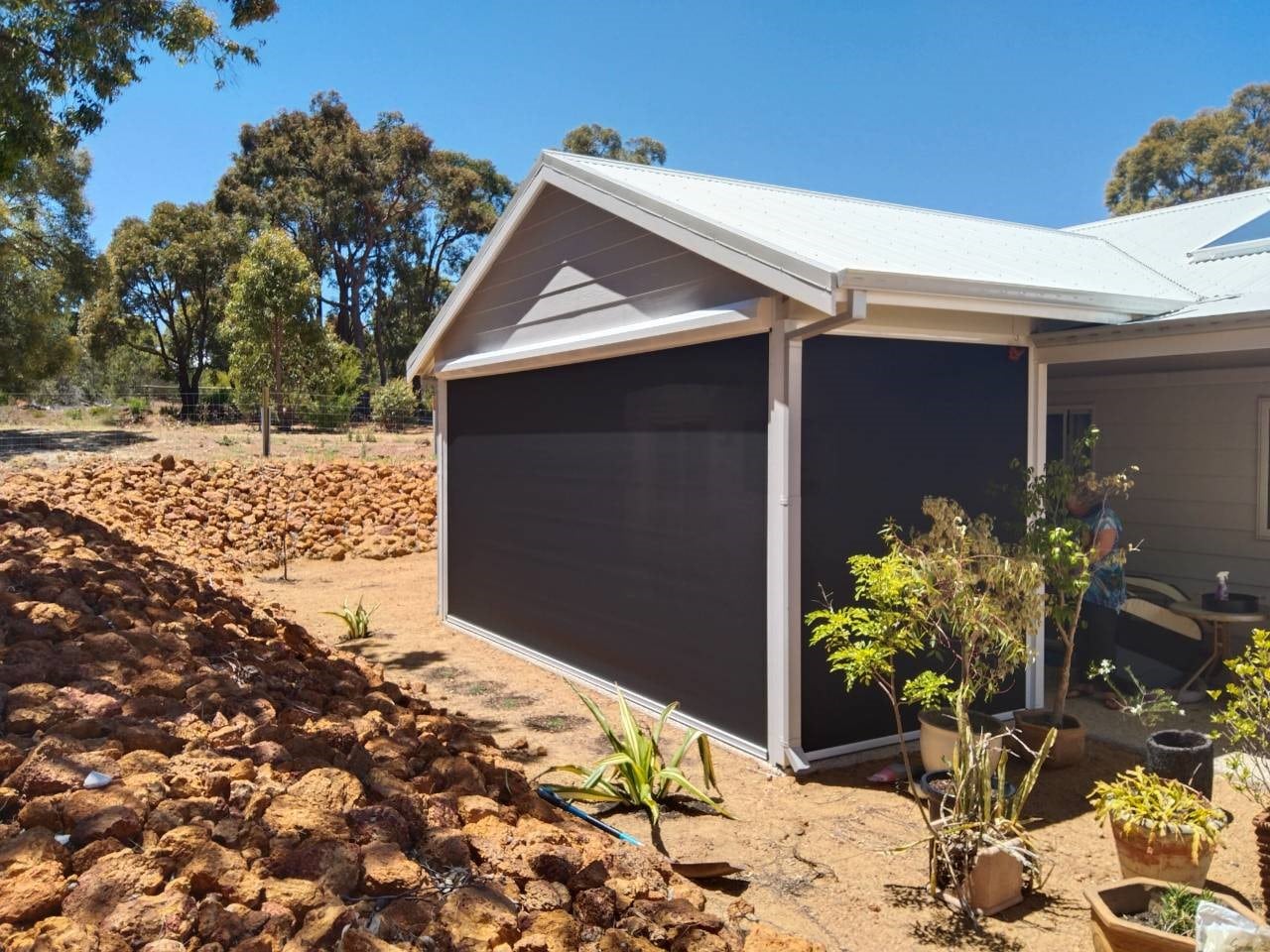 another shot of 2 outdoor ZIptrak® Blinds installed on a gable end farm styled home